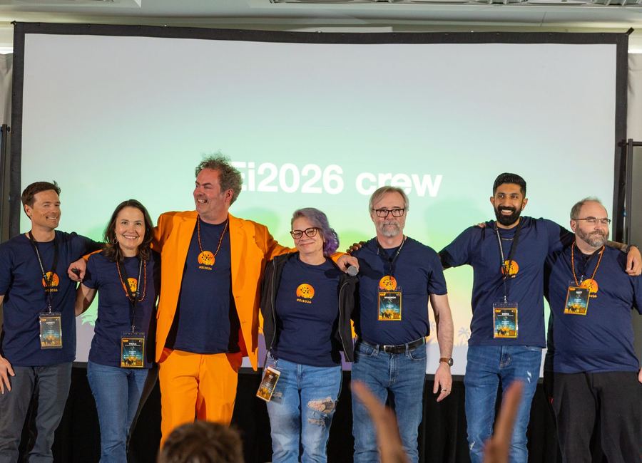 The event crew together on stage at a previous Optimizers community event