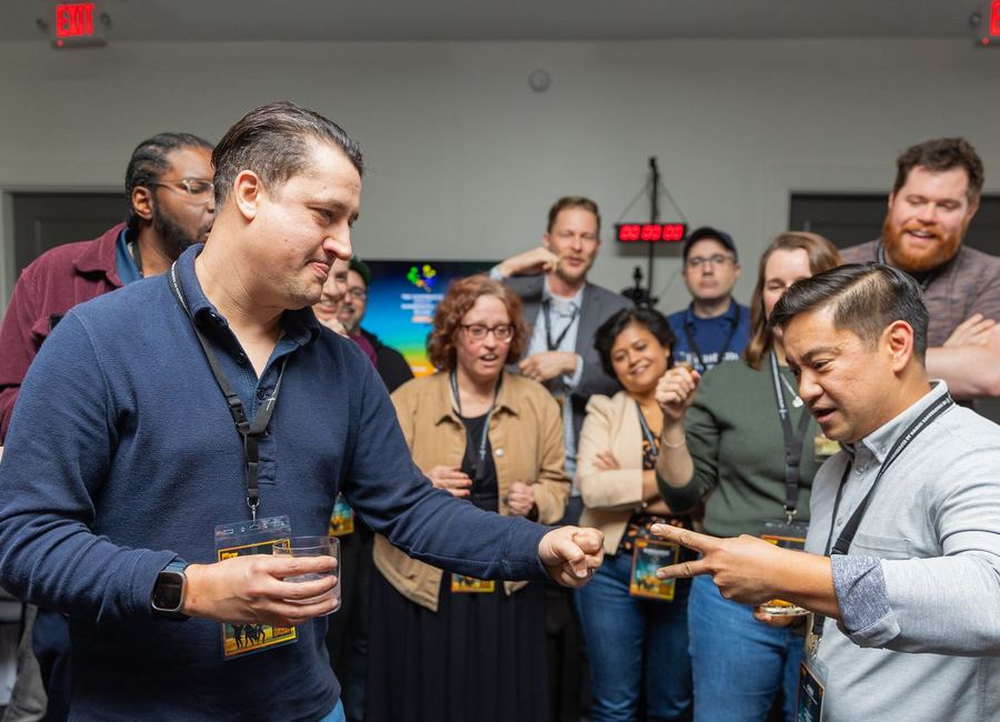 Attendees laughing and playing together at a previous Optimizers community event
